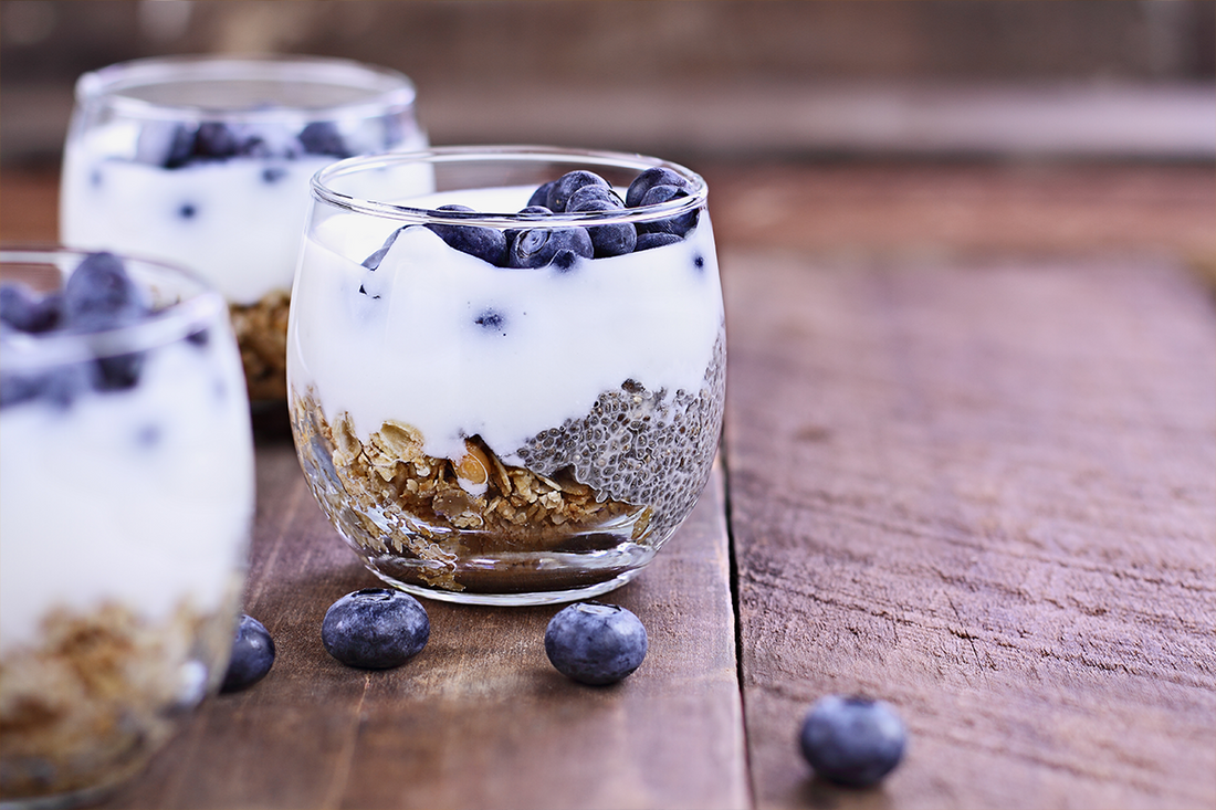 Berries, yogurt, and oats in a glass. Berries and yogurt being a good example of probiotics